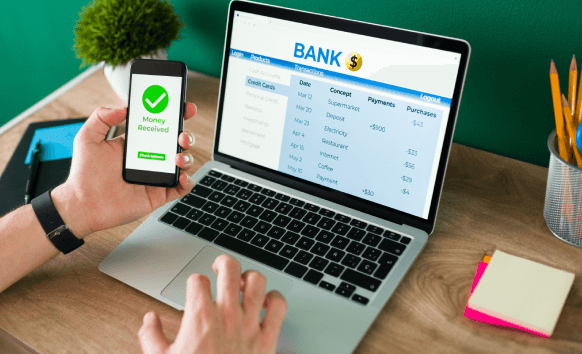 A man works on a laptop for banking translation, representing different types of bank statement translations for financial.