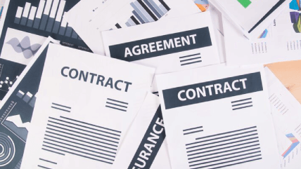 Business professional analyzing reports, showcasing meticulous contract translation services for various document types. Business professional analyzing reports, showcasing meticulous contract translation services for various document types.