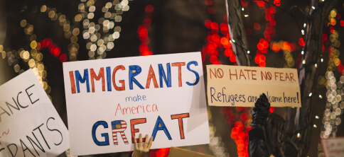 Protesters hands holding placards in support of immigrants