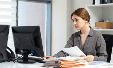 Professional working with documents, emphasizing the importance of lease document translation for different cultural contexts Professional working with documents, emphasizing the importance of lease document translation for different cultural contexts