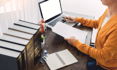 Woman using a laptop for product, highlighting accurate translation services for life sciences regulatory compliance. Woman using a laptop for product, highlighting accurate translation services for life sciences regulatory compliance.