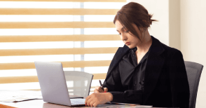 A professional works on her laptop in an office, highlighting affordable technical translation services in Washington, DC.