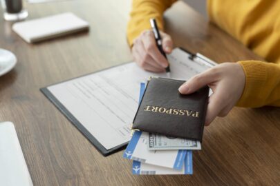 A person holding a passport and filling out an immigration application form, with a help of professional translator